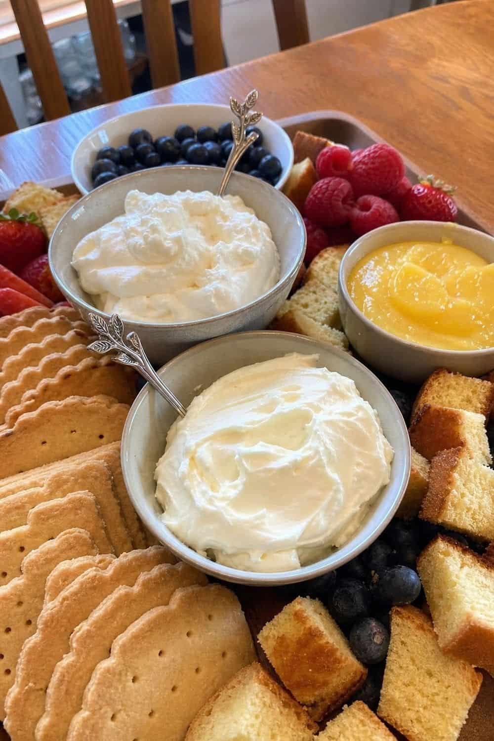 20 New Year's Eve Dessert Board Ideas for Easy Hosting New Year's Eve dessert board idea with use whipped cream or mascarpone dip