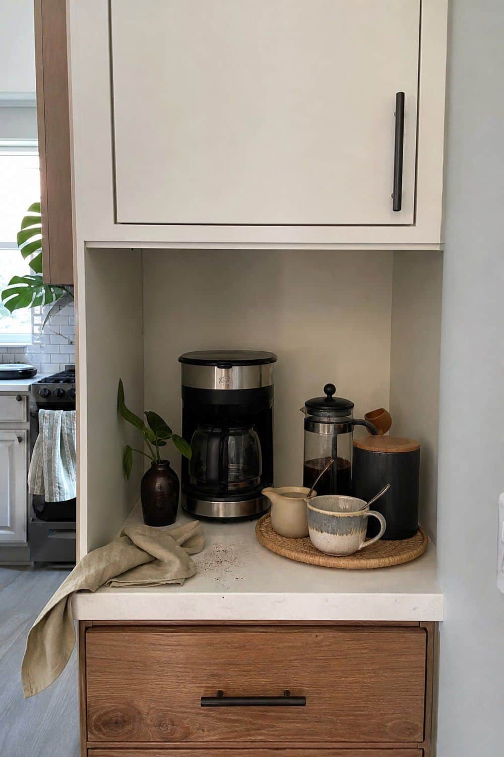 25 Studio Apartment Kitchen Ideas for Calm One-Room Living Coffee supplies arranged on a single cabinet shelf