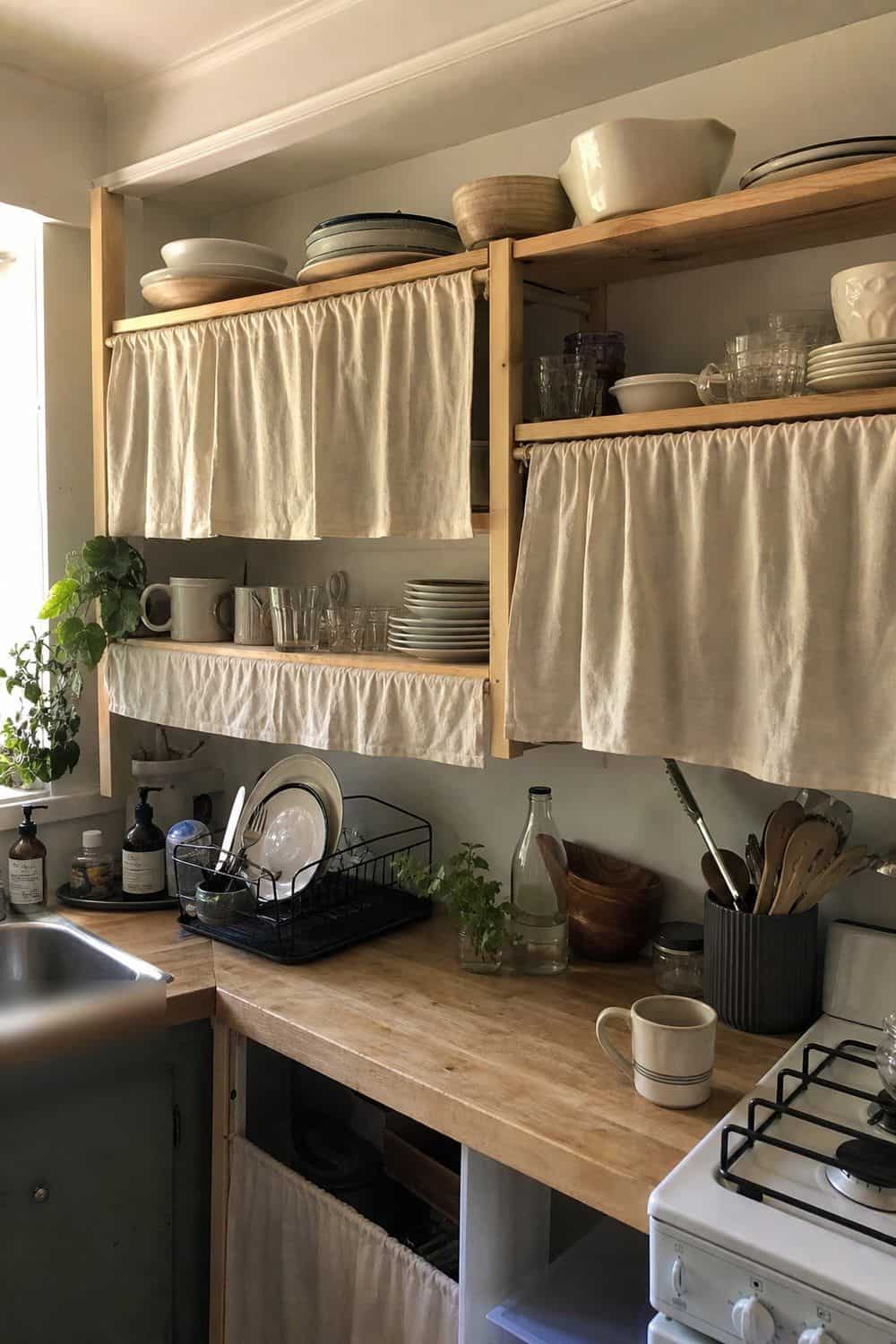 25 Studio Apartment Kitchen Ideas for Calm One-Room Living Cafe curtain on a tension rod covering open kitchen shelves