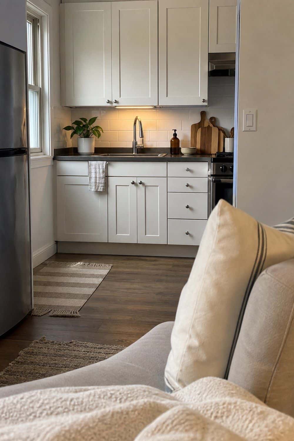 25 Studio Apartment Kitchen Ideas for Calm One-Room Living Roll-up drying rack over a tidy kitchen sink