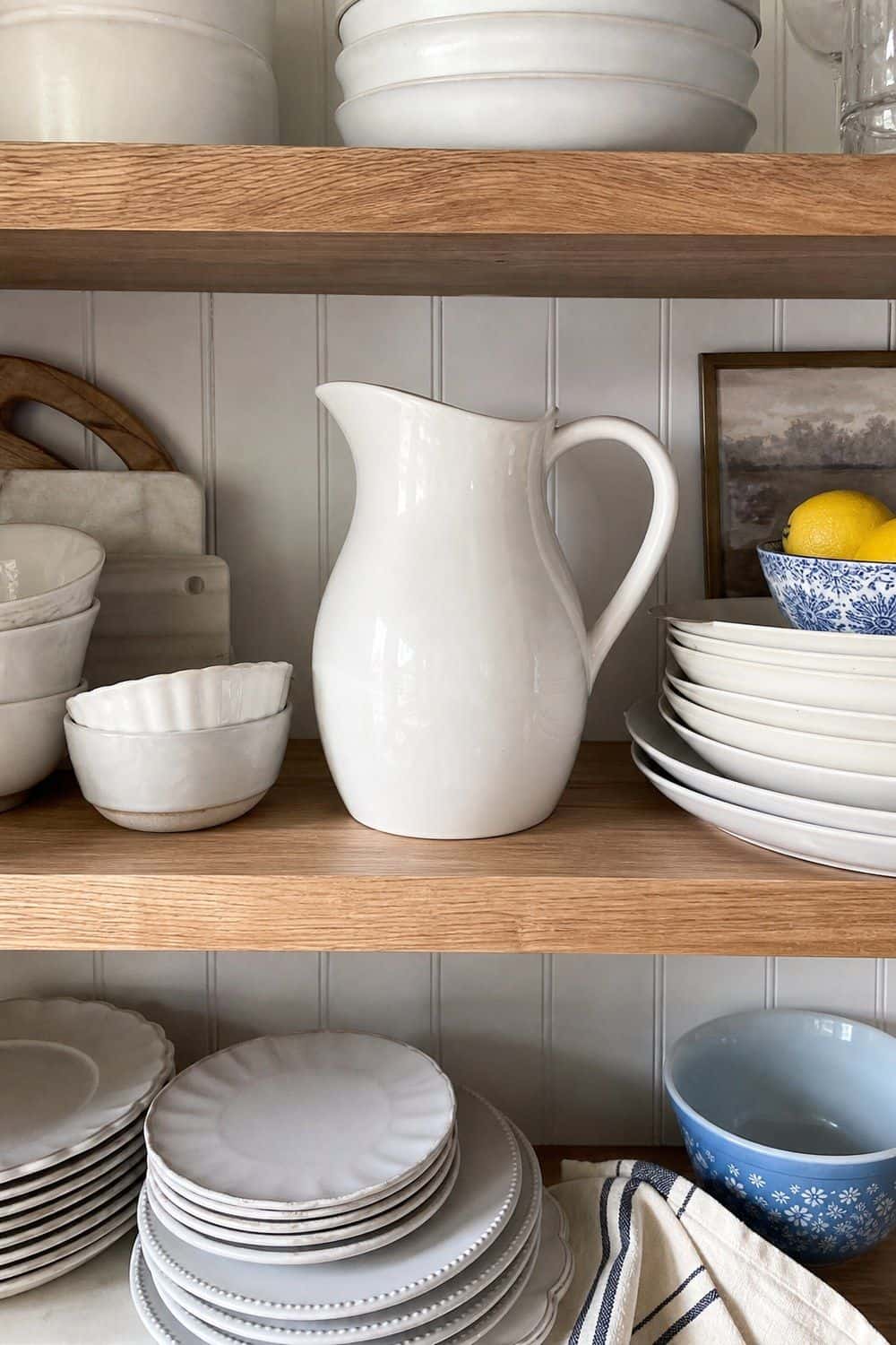25 Summer Kitchen Decor Ideas for a Lighter Seasonal Look White Ceramic Pitcher on Shelves in a bright, realistic summer kitchen setting