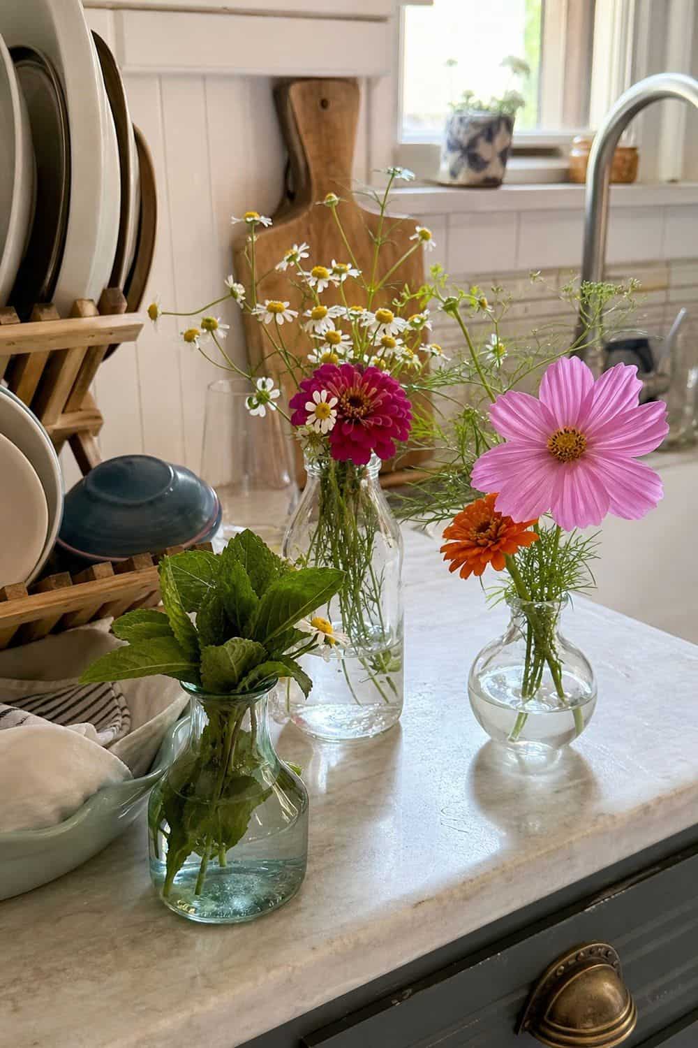 25 Summer Kitchen Decor Ideas for a Lighter Seasonal Look Bud Vases for Farmers Market Stems in a bright, realistic summer kitchen setting