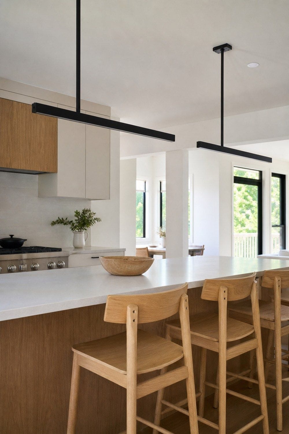 25 White Oak and Black Kitchen Ideas for High-Contrast Warmth Black Linear Pendants Over Oak Seating in a white oak and black kitchen